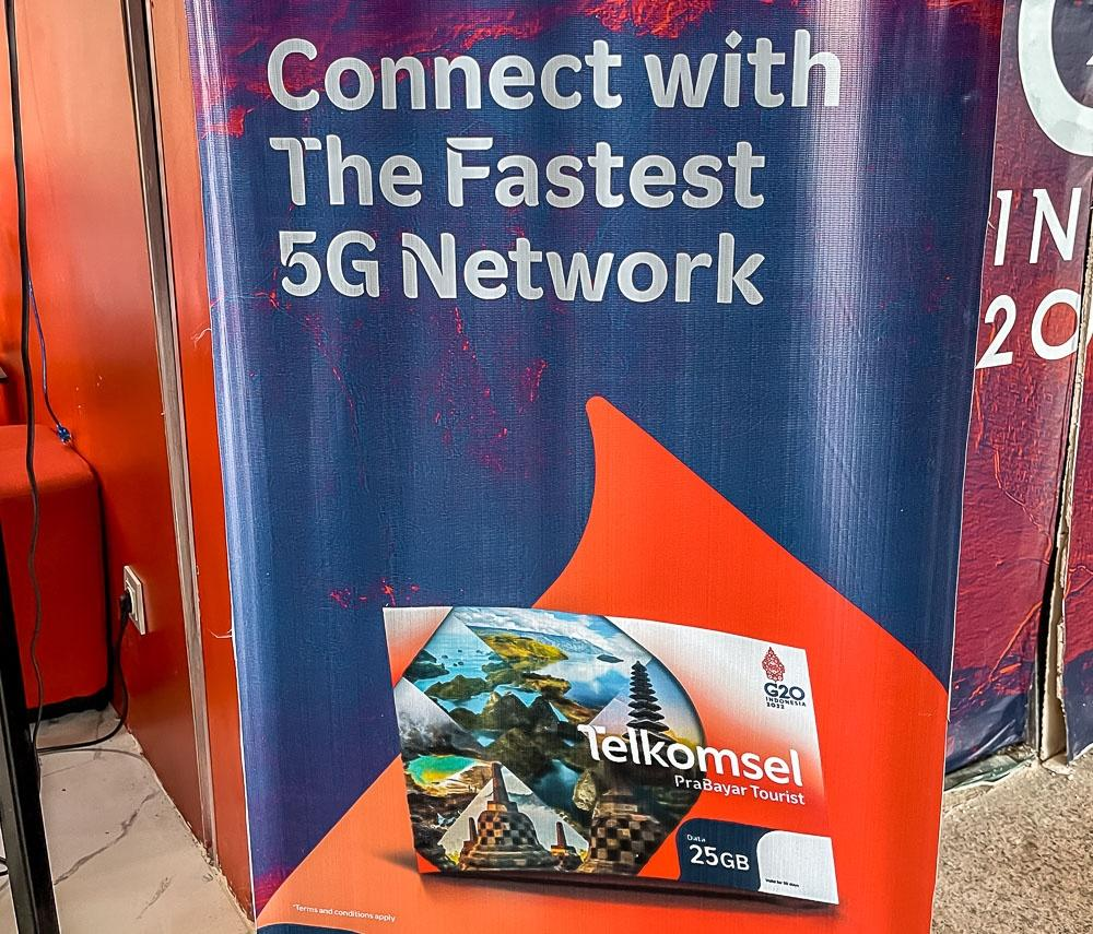 Telkomsel “Prepaid Tourist” SIM advertisement at Bali’s airport, highlighting its 5G network